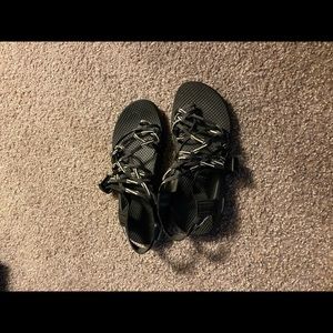Black and white strap Chacos. Includes toe strap